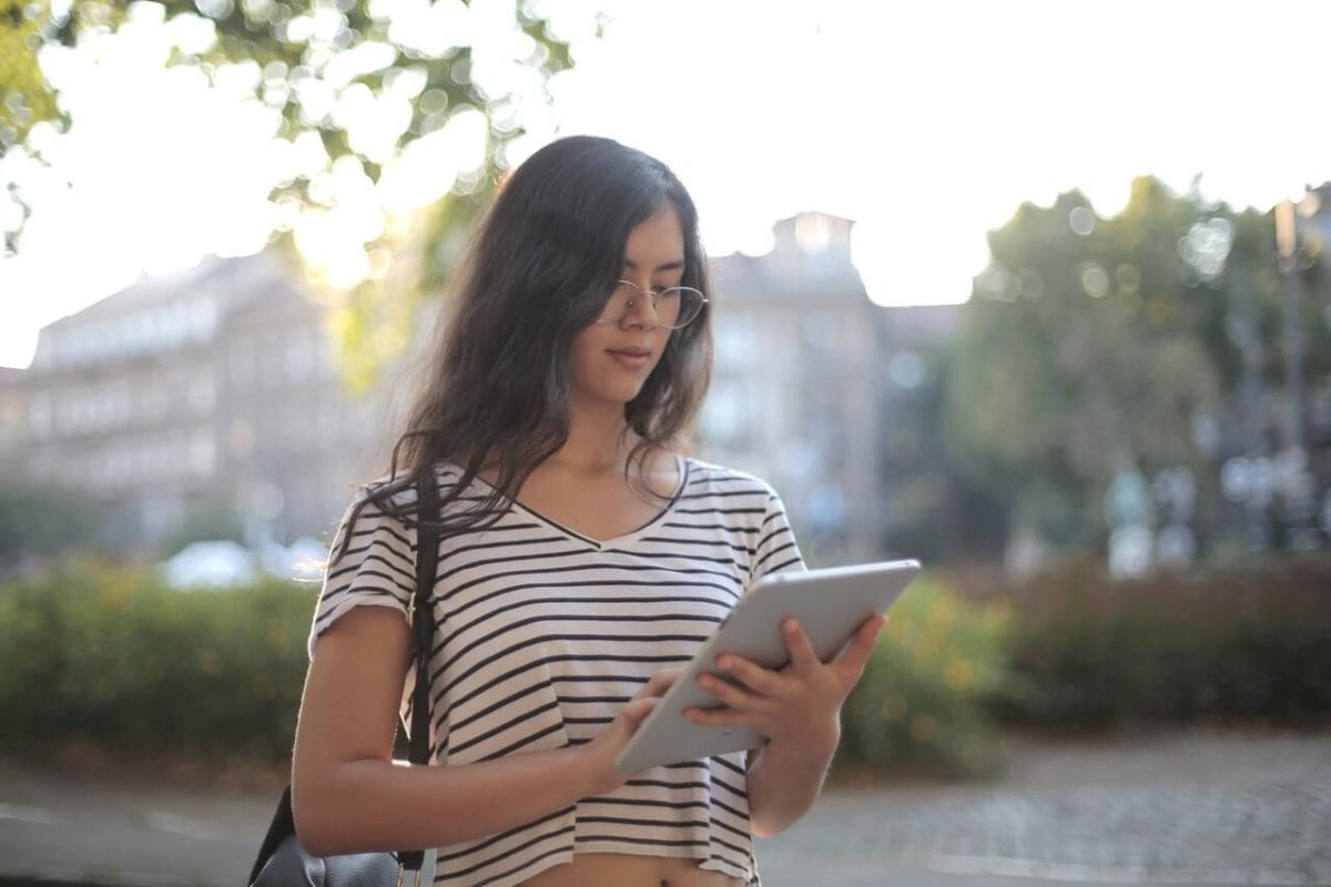 Young lady using a co-parenting app on tablet