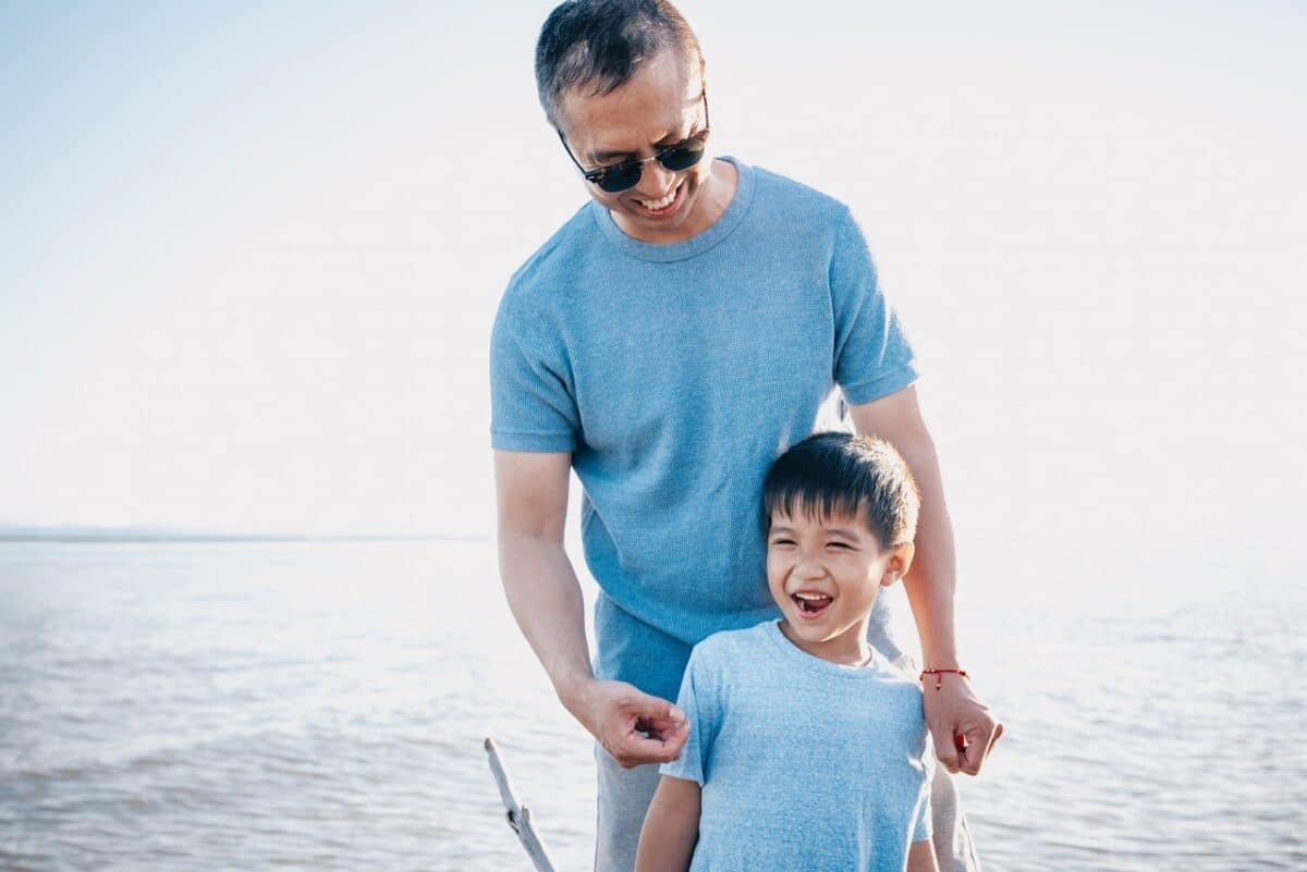 Happy grandfather and child laughing by the sea parenting orders for grandparents