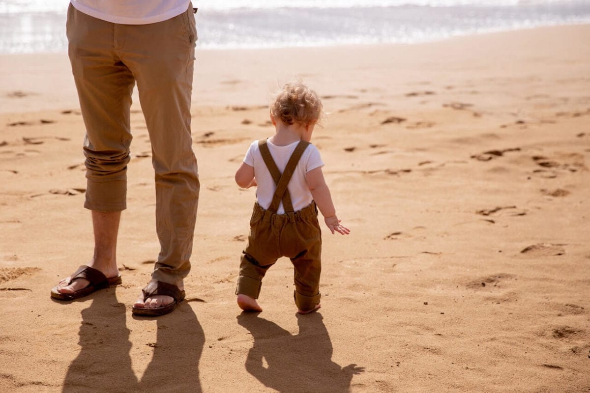 Father and child on beach wondering about presumption of paternity