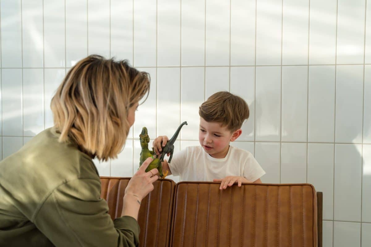 Mother playing with child has a successful parallel parenting plan