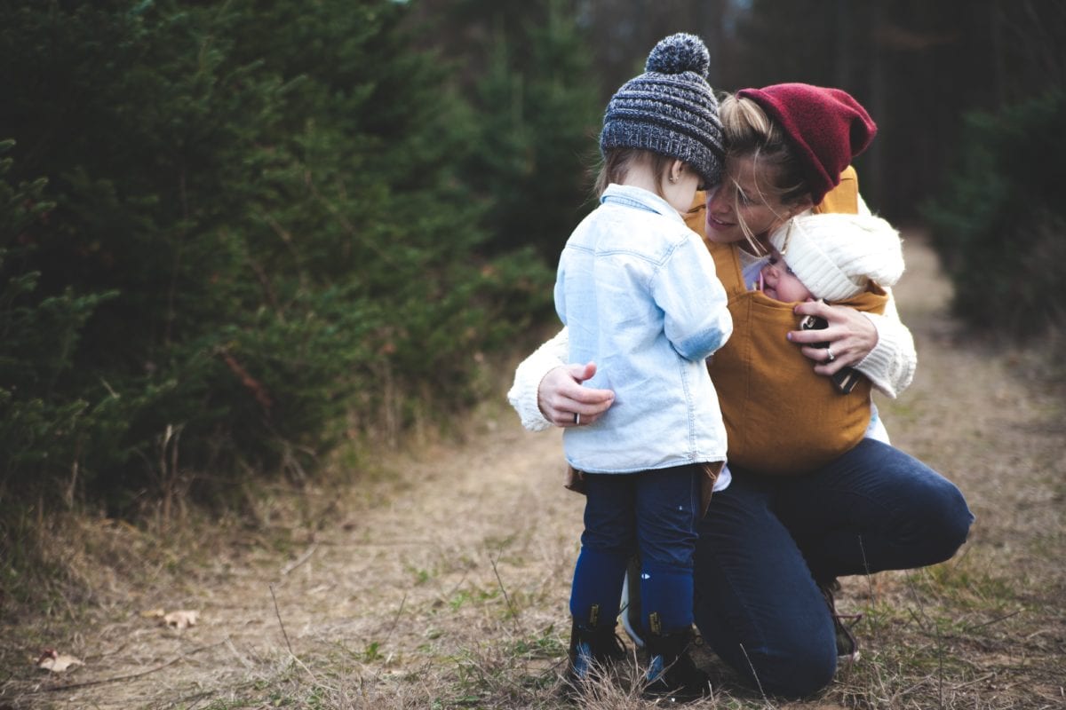 Parent is hugging Financial Institutions outdoors after experiencing domestic violence and family law